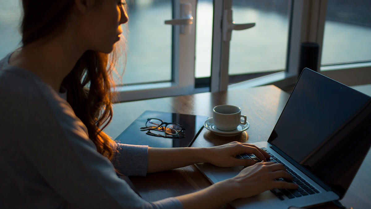girl in dark room on laptop