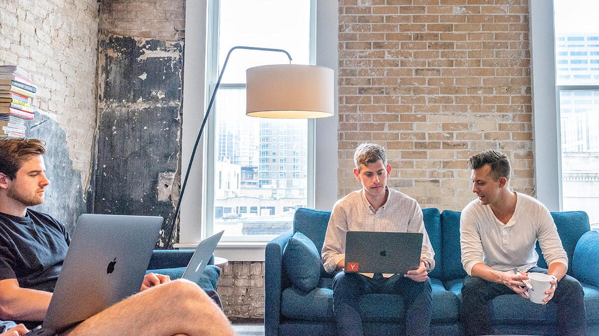 team in trendy office on sofas
