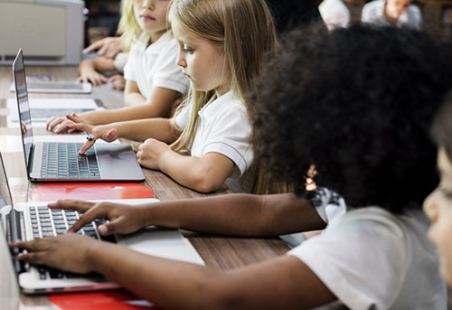 young students using laptops