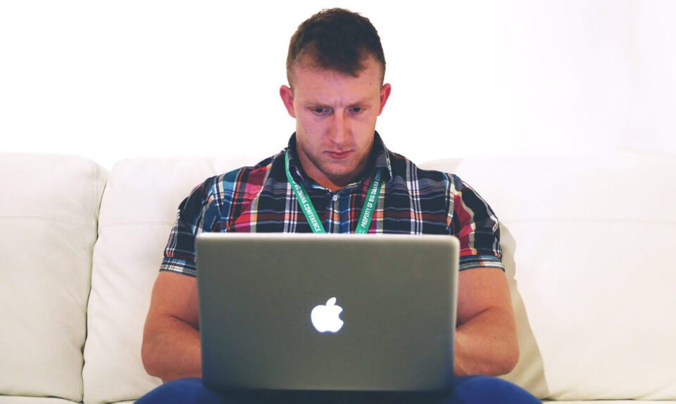 concentrating man working on apple macbook