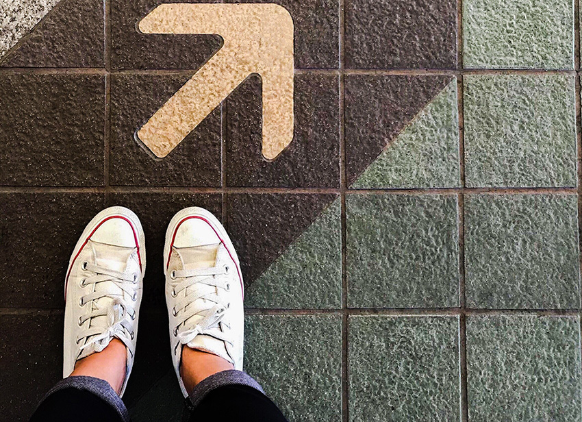 shoes on floor with an arrow