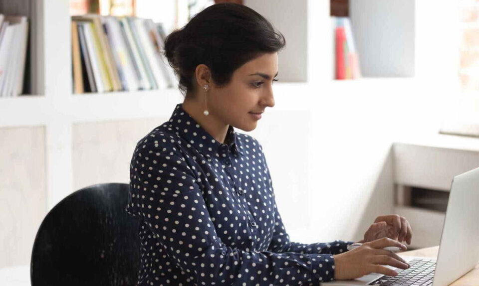 professiona lady in spotted shirt working
