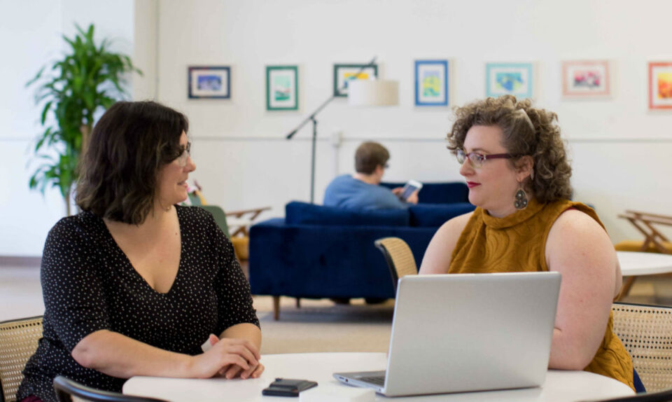two women at a desk in a meeting