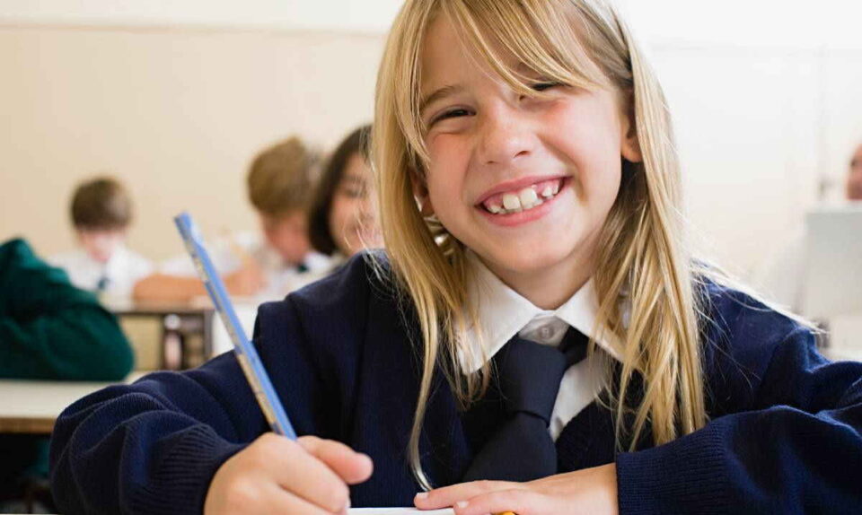 smiling blonde student with pen