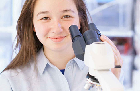 student with microscope