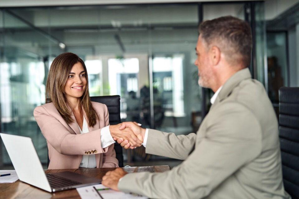 two professionals meeting and shaking hands