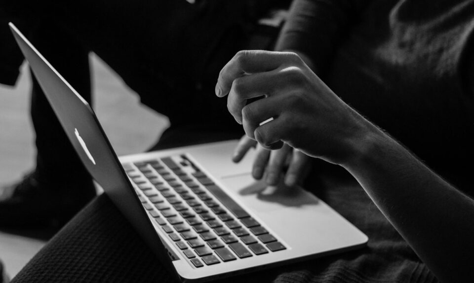 black and white image of someone using a computer