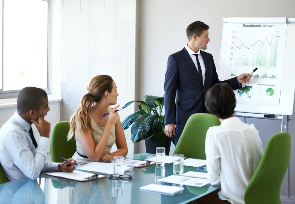 man giving presentation in board room