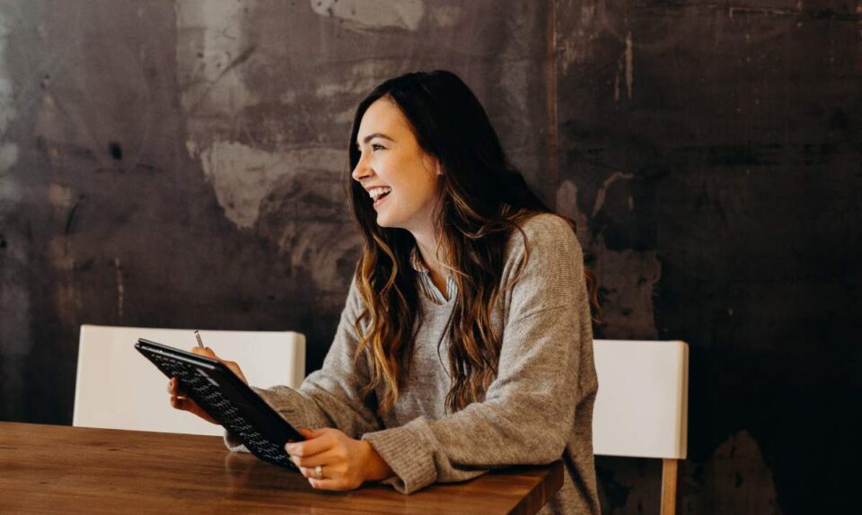 happy lady holding clipboard