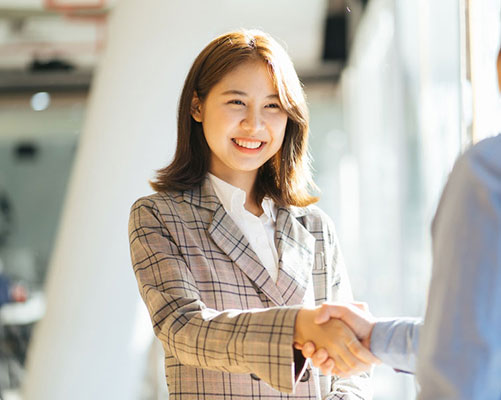 lady in jacket shaking hands