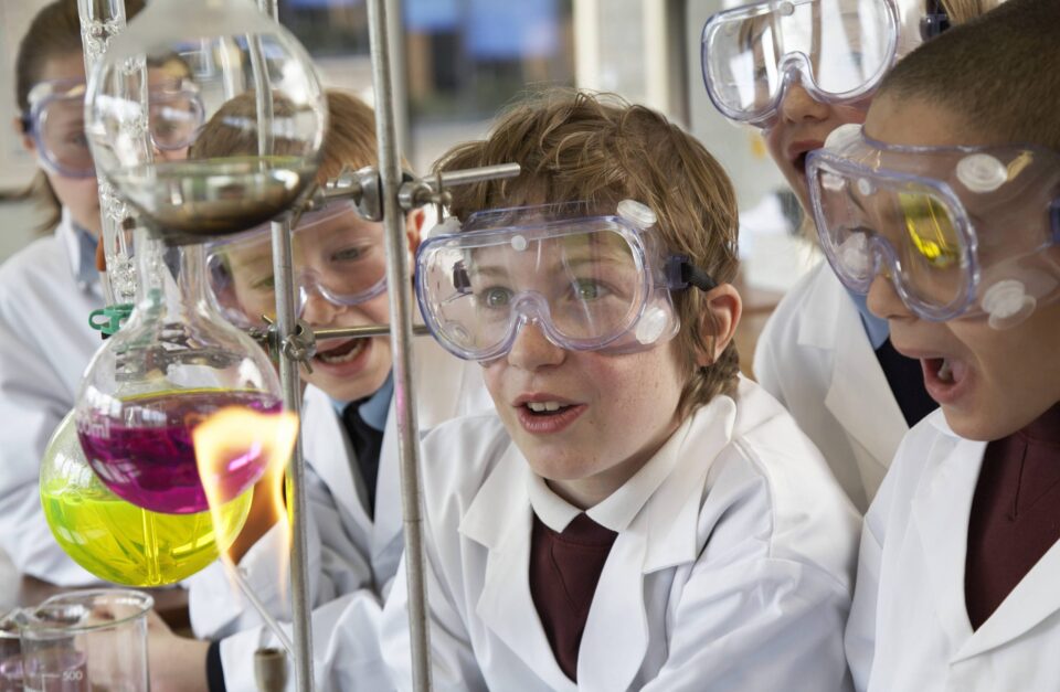 male school student doing chemistry