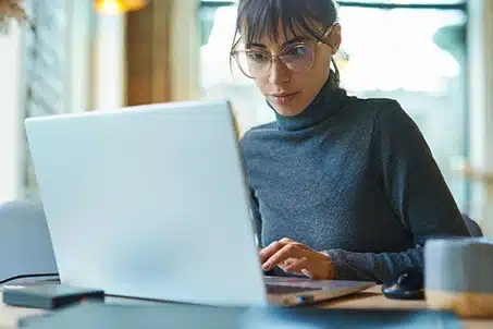 lady in glasses using laptop