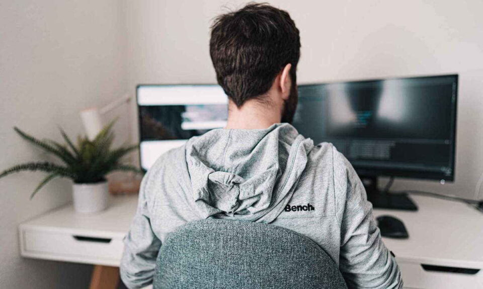 man working at computer at home