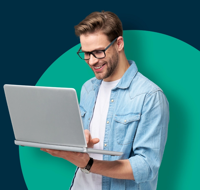 guy holding laptop working on assessment testing software