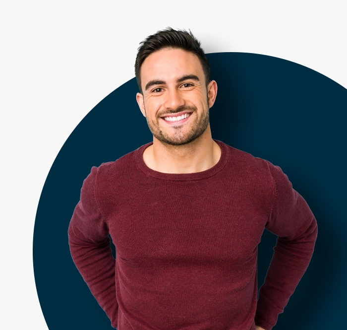 man in maroon top smiling