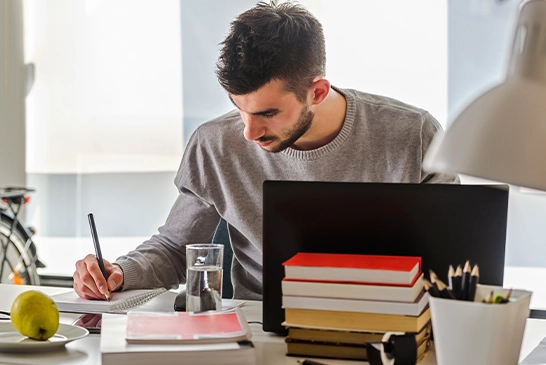 student at home on laptop working on assessment software