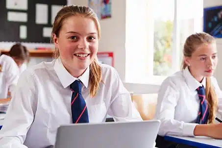 smiling young female student at desk