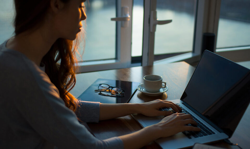 lady in dark room on computer